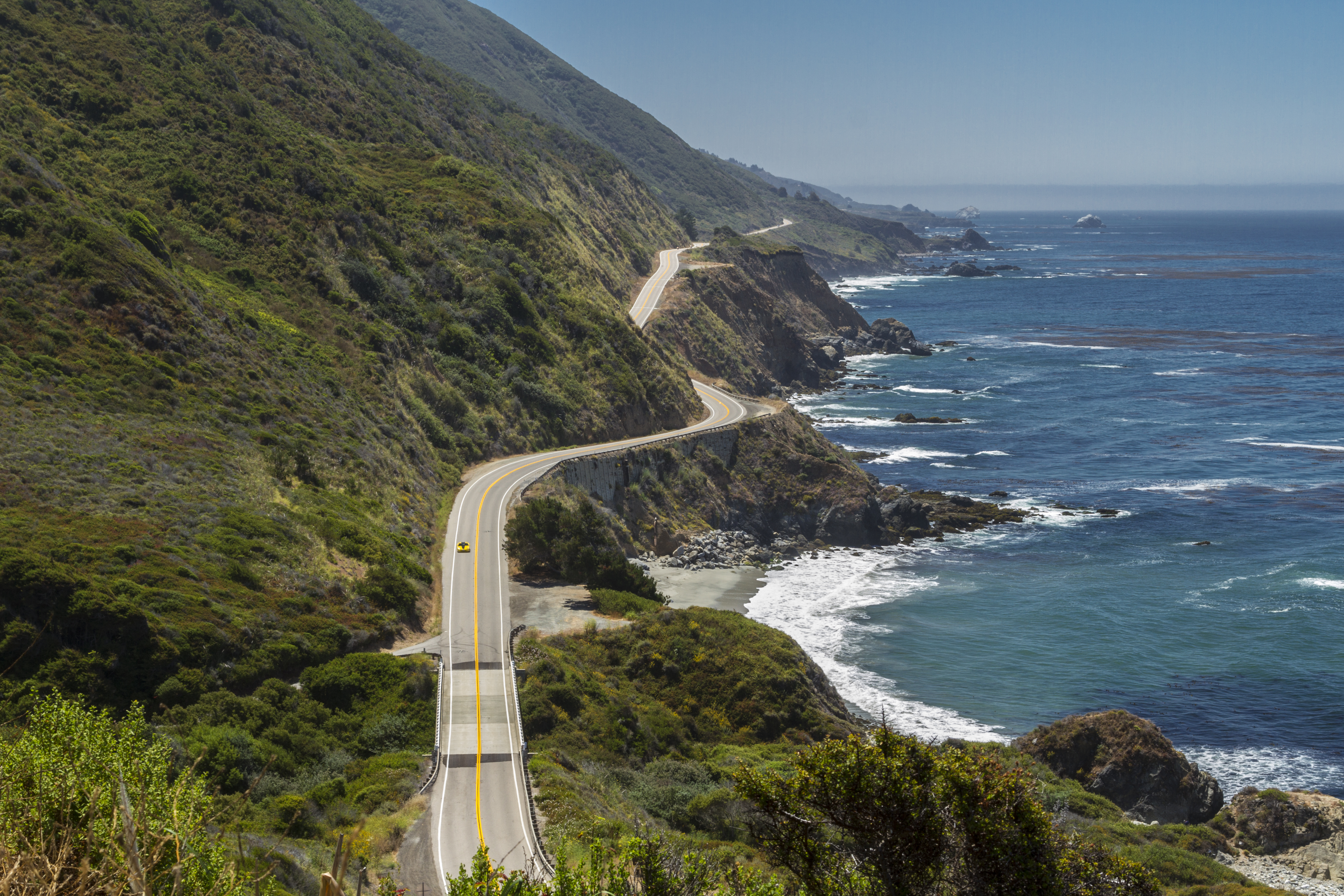 Highway 1 winding along the rugged Big Sur coastline above the Pacific Ocean