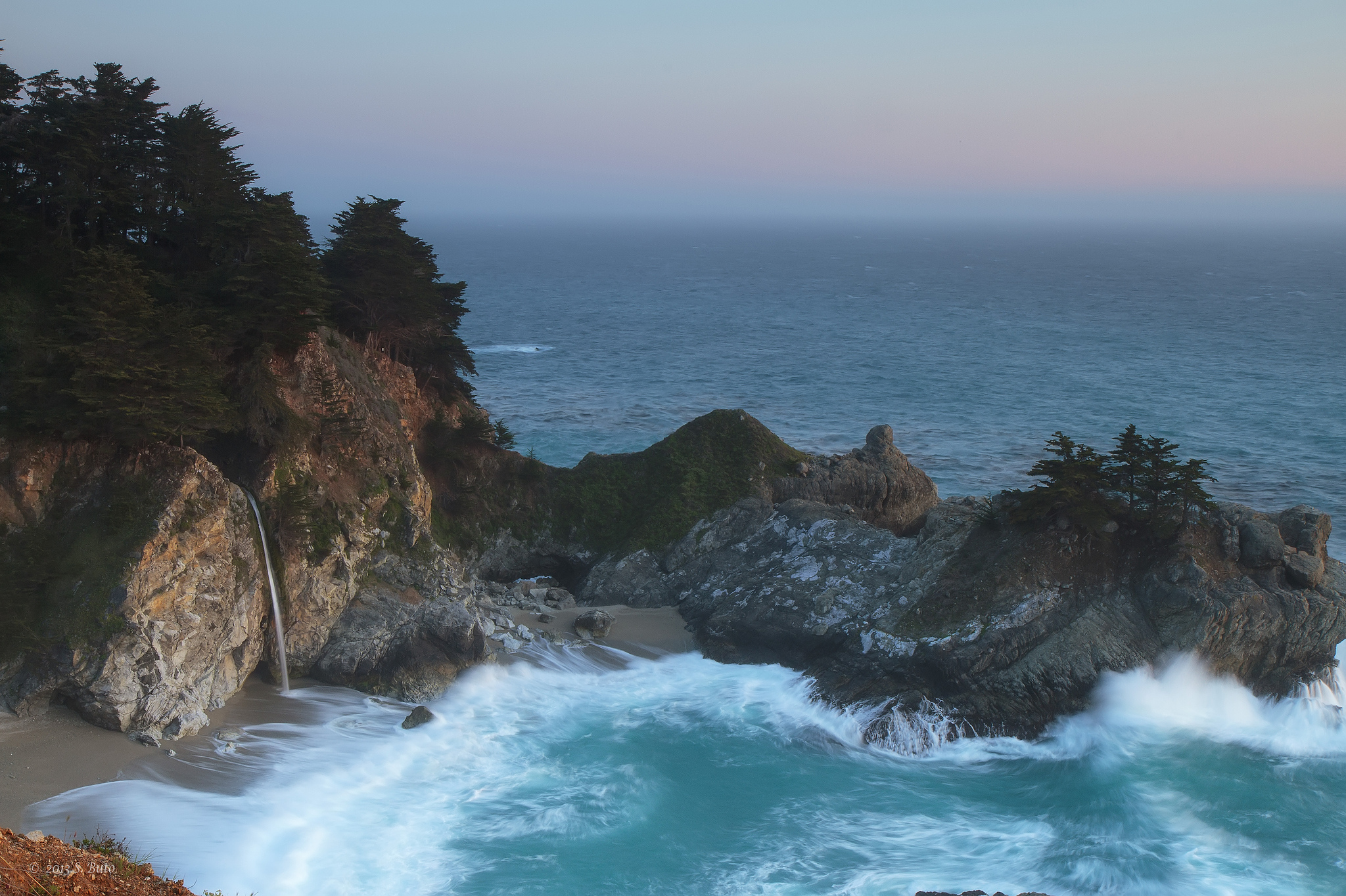 McWay Falls dropping toward a protected coastal cove in Big Sur