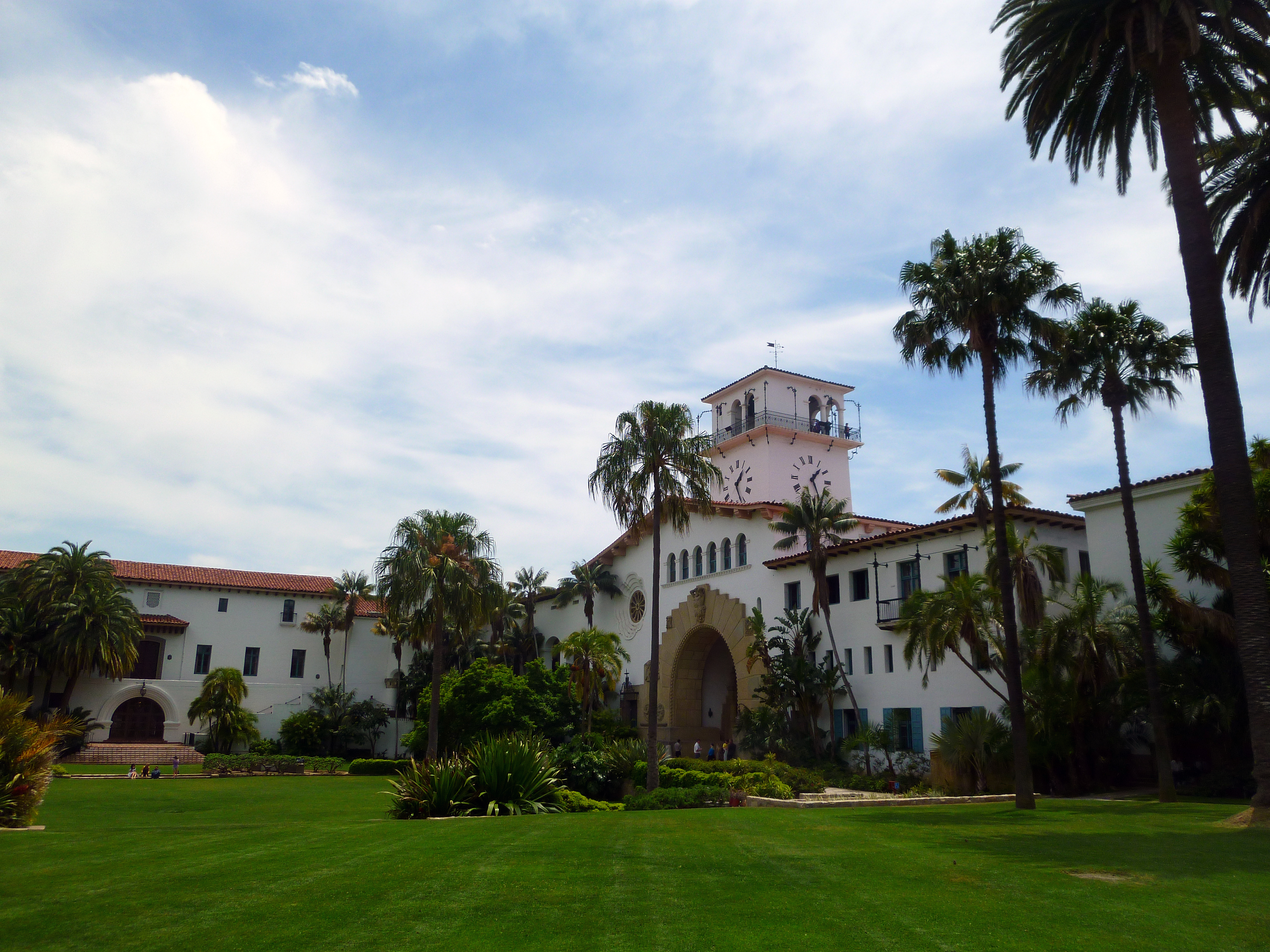 Santa Barbara County Courthouse with its white stucco walls, clock tower, red-tile roof, and palm trees