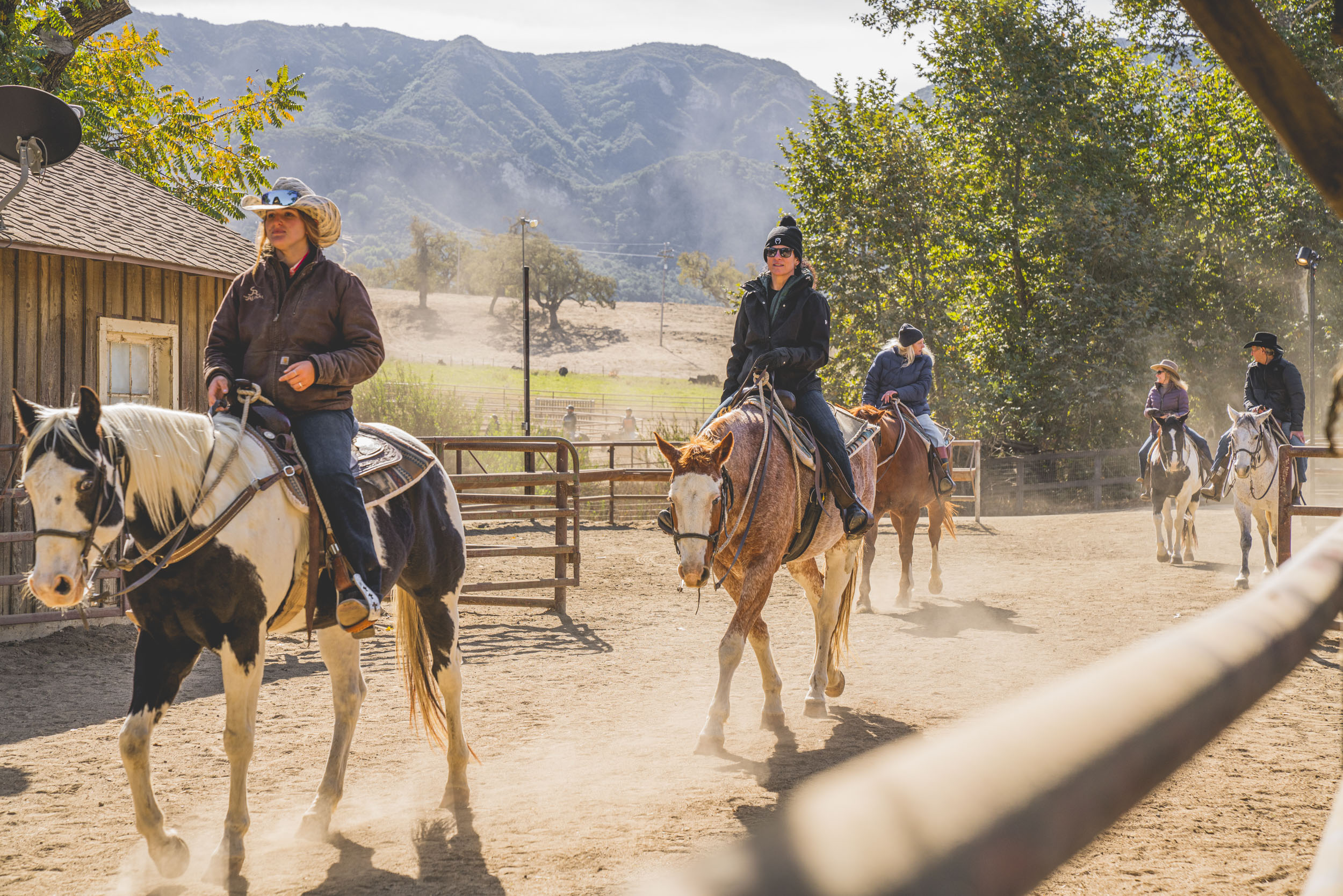 Horseback riders crossing the ranch landscape at Alisal Ranch in the Santa Ynez Valley