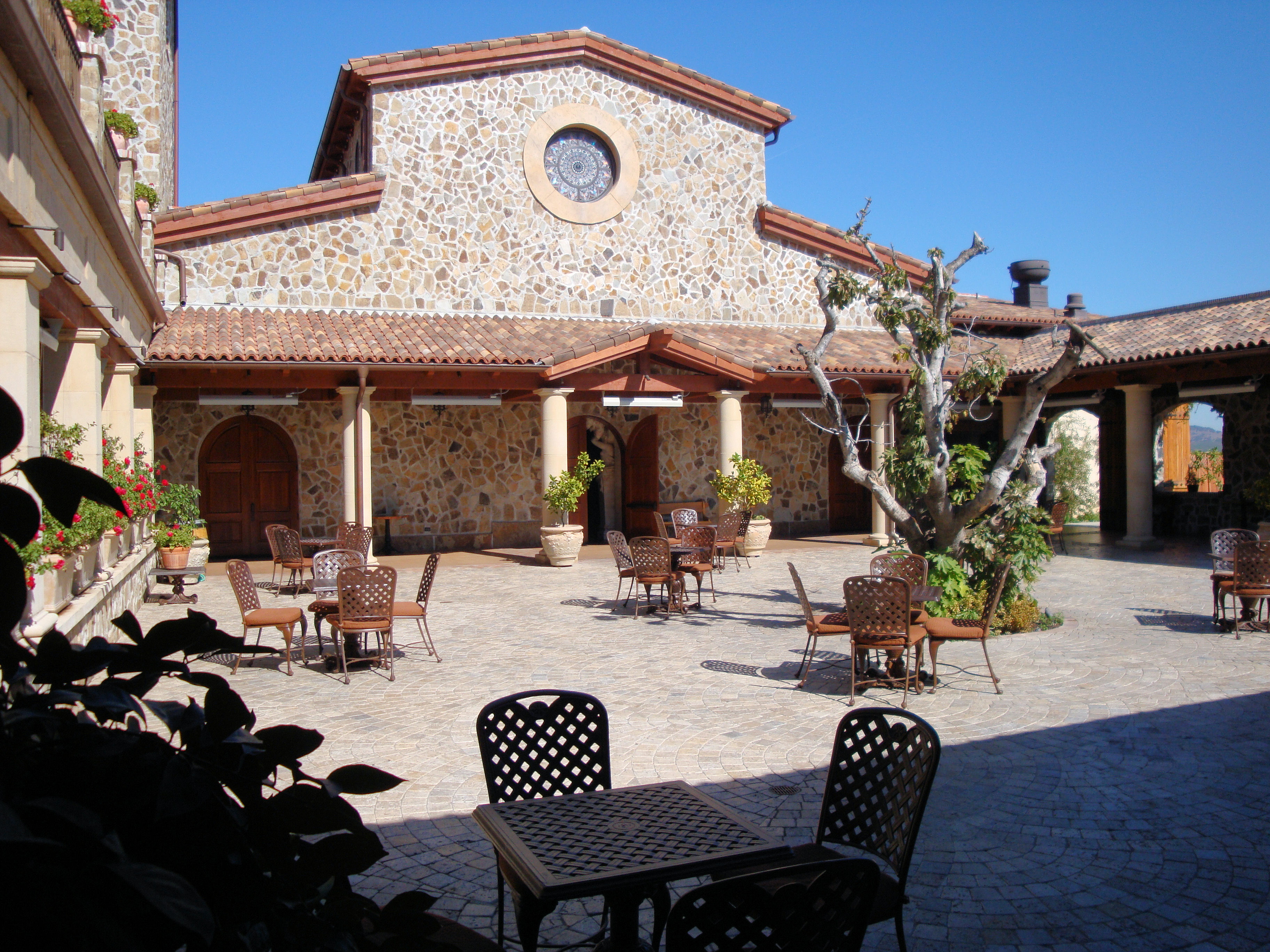 Stone courtyard and outdoor seating at Jacuzzi Family Vineyards in Sonoma